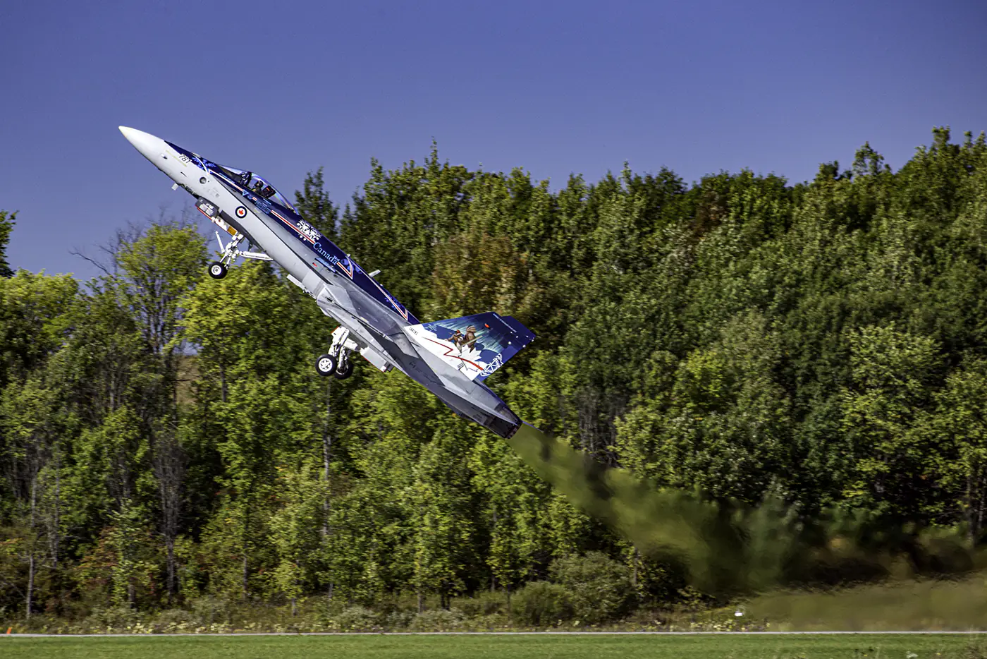 A CF-18 Hornet piloted by Captain Patrick Gobeil thrusts off a runway.  Photo by Jeffrey Meyer.