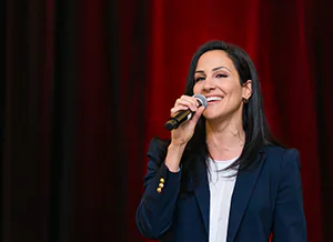 A talented singer sings the Canadian anthem as an event opening.  