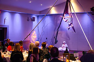 A gymnast performs before a fundraising event.  Audience perspective.   Photo by Jeffrey Meyer.