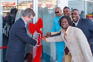 Four brother celebrate the grand opening of their store with the Mayor and a red ribbon cut.   Photo by Jeffrey Meyer.