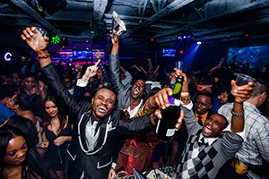 A crowd raises a toast of champagne and cheers to celebrate:  three, two, one, Happy New Year!   Photo by Jeffrey Meyer.